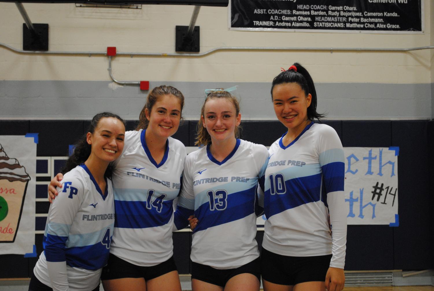 (From left to right) Seniors Melissa Grande, Libby Penn, Courtney Johnson, and Chloe Chanren pose for a picture before their last match of the season.
