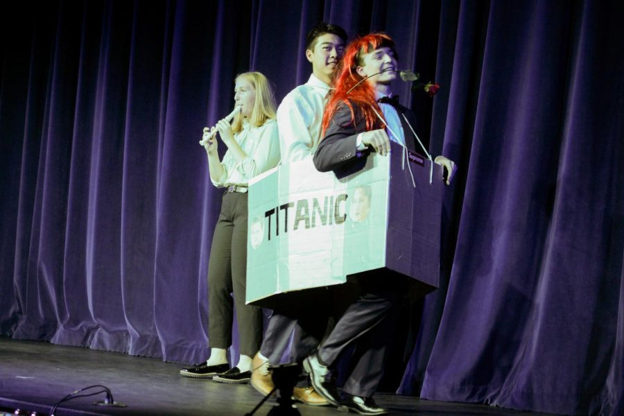 Evan Gi 20 and Charlie McCormick 20 as Jack and Rose from The Titanic with Maggie Cole 20 playing recorder in the background.