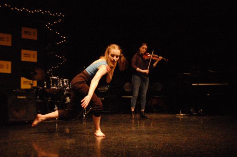 Julia Boberg 20 dances to her sisters violin accompaniment at Amnesty Coffeehouse.